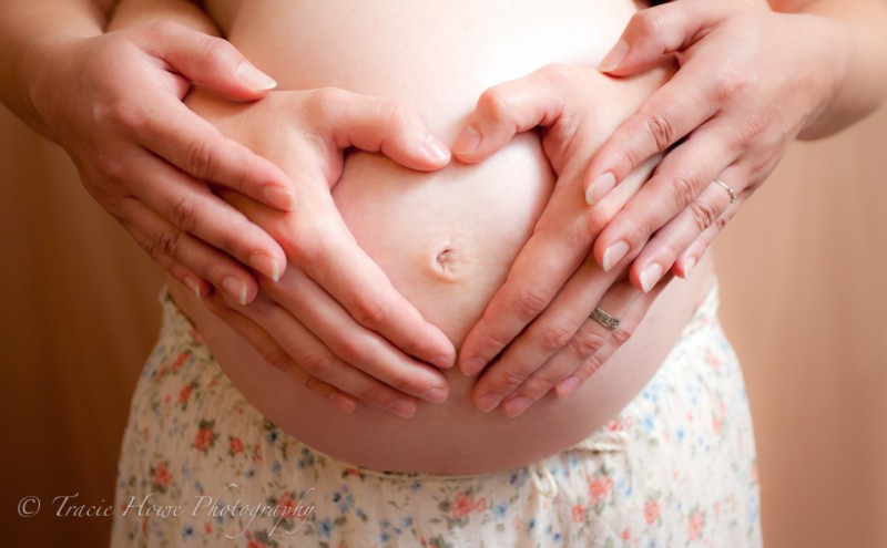 Maternity photo with husband and wife hands
