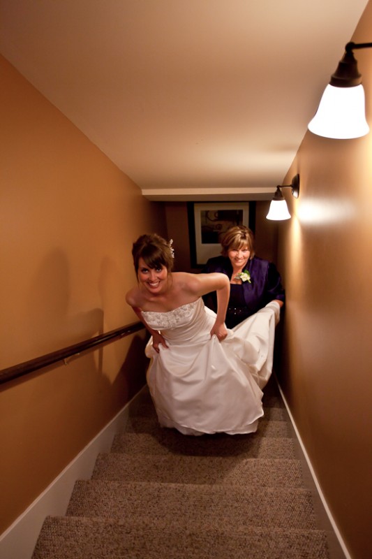Photo of bride and mother walking up stairs