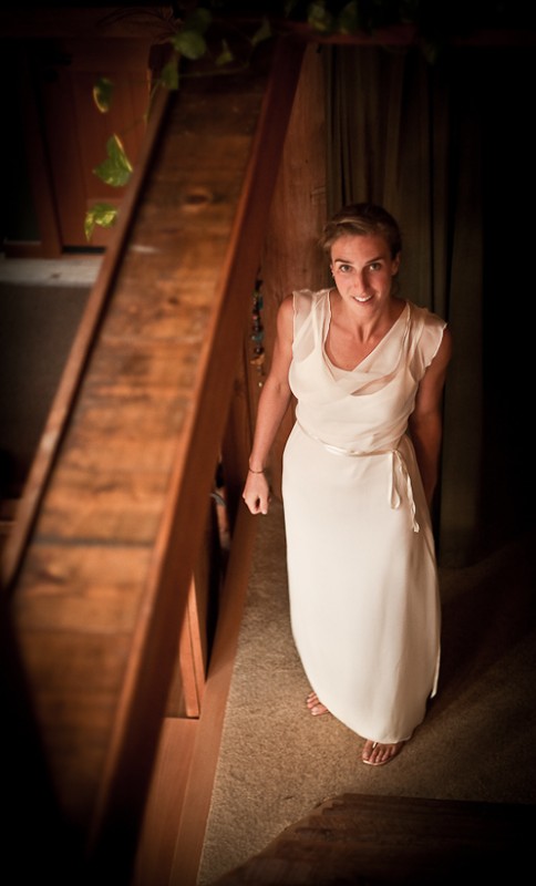 Photo of bride at foot of stairs