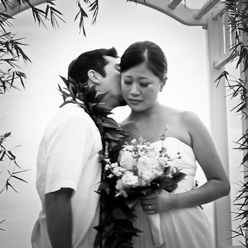 Photo of bride and groom kissing after wedding in Hawaii