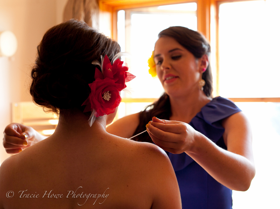 Photo of a sister helping the bride get ready