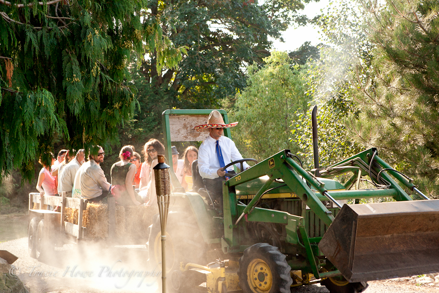 Photo of guests arriving at a wedding on a tractor