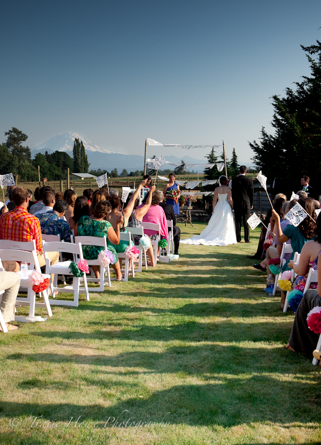 Photo of bride and groom at wedding ceremony with Mt. Rainier in background