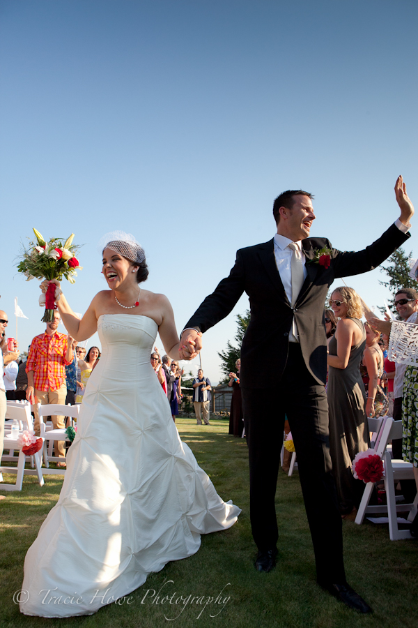 Fun photo of bride and groom running exiting the ceremony