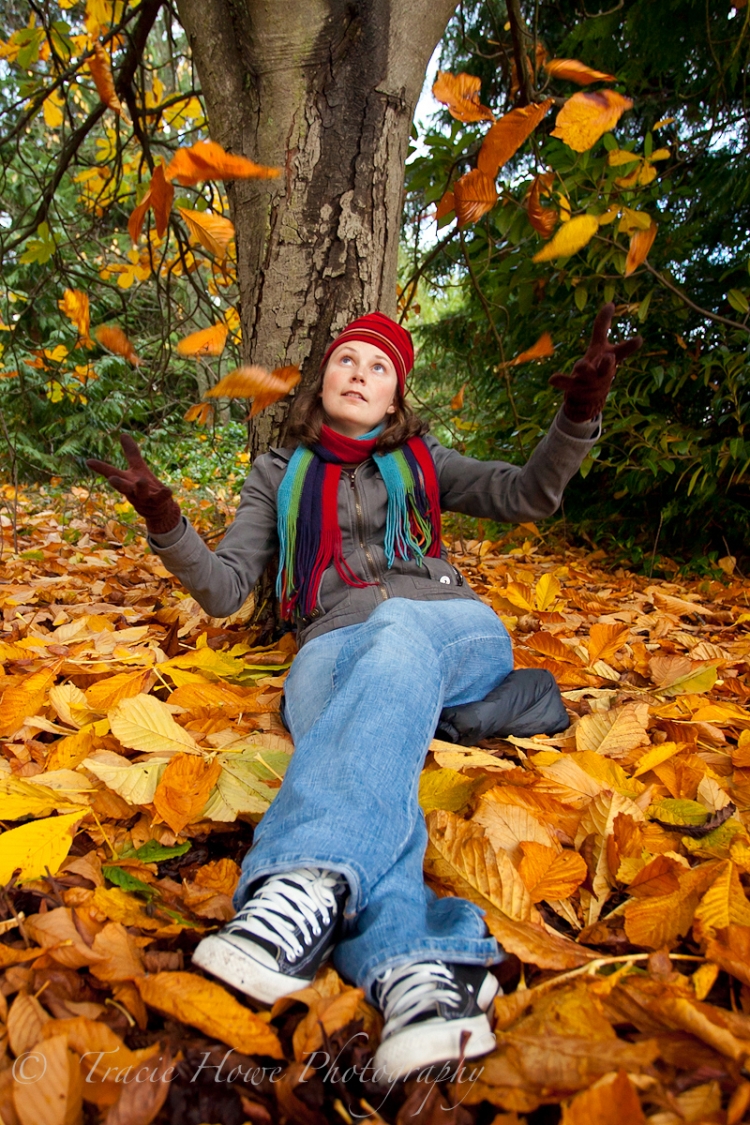 Self-portrait throwing leaves during fall