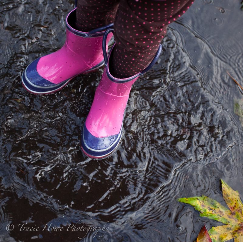 photo of girl standing in puddle