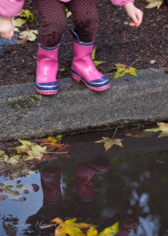 photo of girl about to jump in puddle