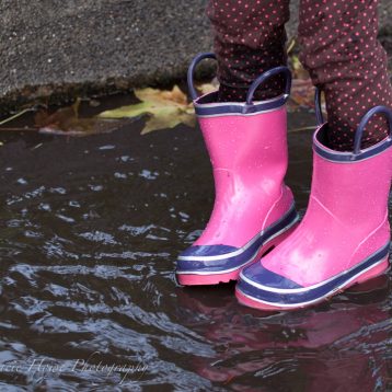 photo of girl standing in puddle with boots