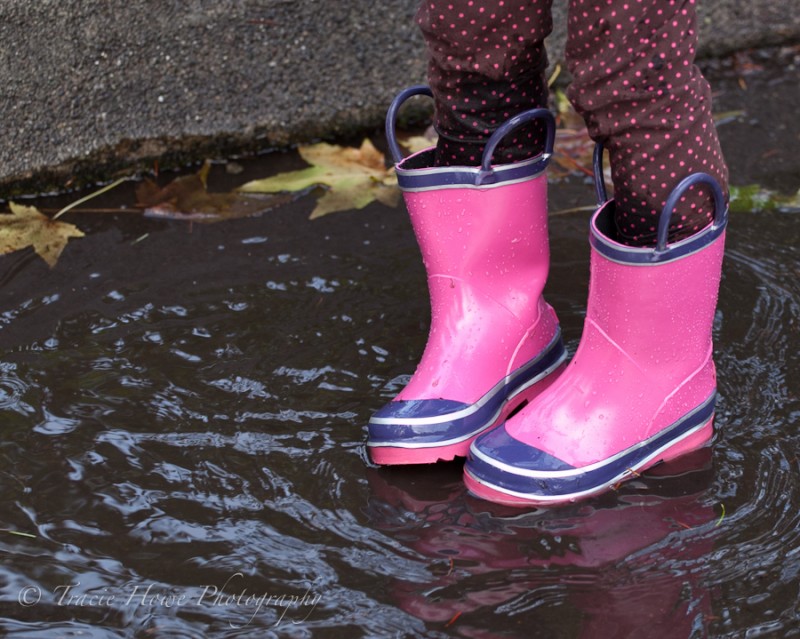 photo of girl standing in puddle with boots