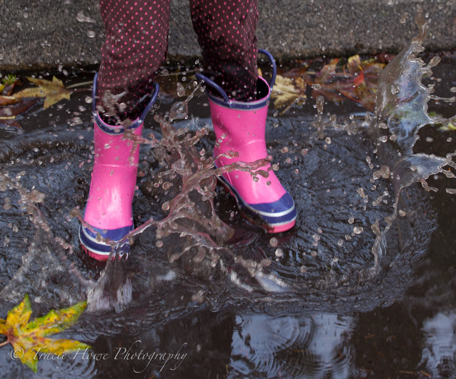 photo of girl splashing in puddle