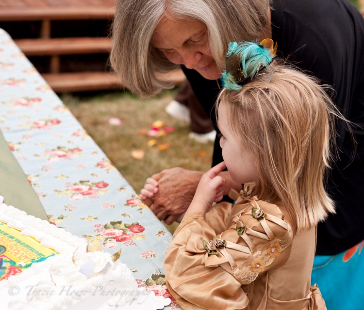 Little girl being caught after trying some wedding cake too soon