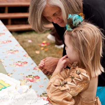 Little girl being caught after trying some wedding cake too soon