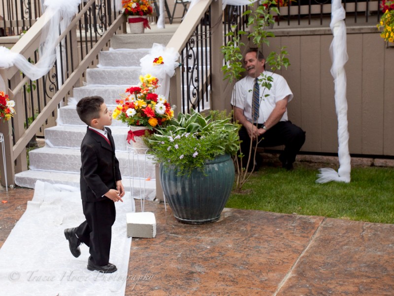 ring bearer playing hide and seek at wedding