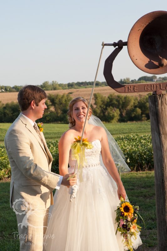 Bride and groom ringing dinner bell after ceremony