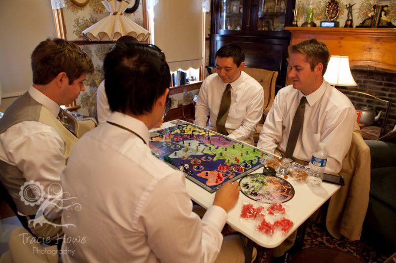 Groom and groomsmen playing Risk before wedding