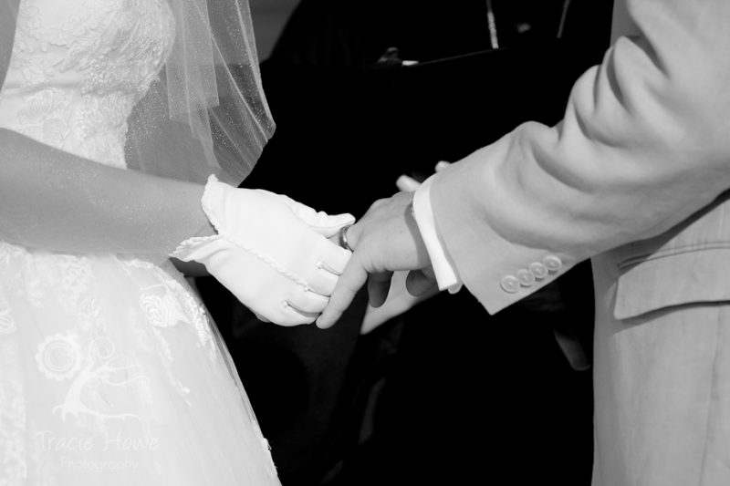 Bride and groom exchanging wedding rings