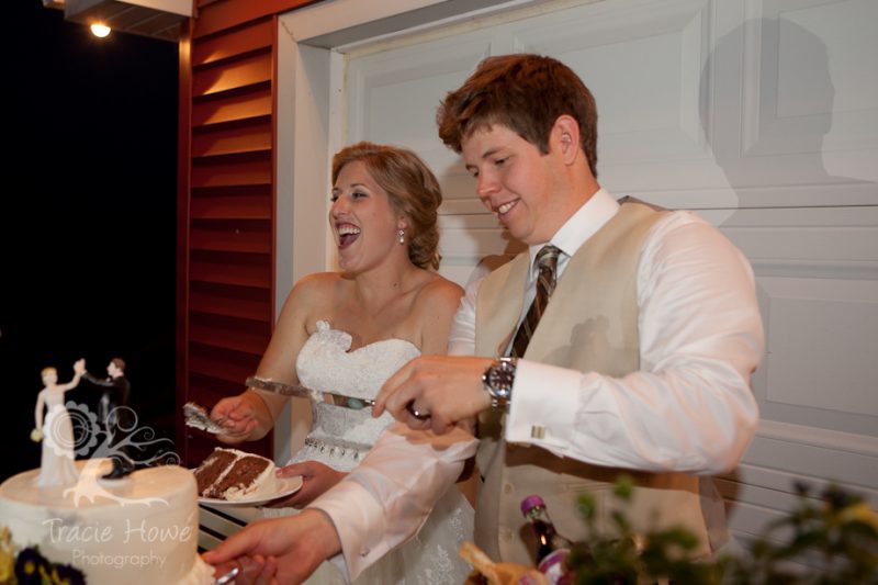 Bride and groom cutting cake at wedding reception