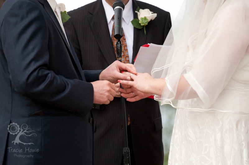 photo of exchanging rings at wedding ceremony